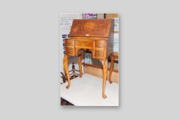 A good 20th Century walnut lady's writing bureau, the fall front opening to reveal an arrangement of