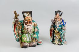 Two 19th Century Chinese figures of well dressed elderly gentleman, each holding a staff in one hand