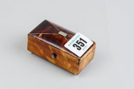 An oblong silver mounted tortoiseshell patch box with slightly domed lid on corner porcelain