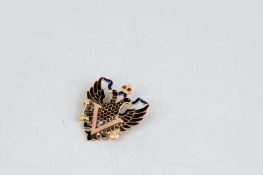 A Russian nine carat gold and enamelled War Victory brooch depicting a pair of eagles with crown