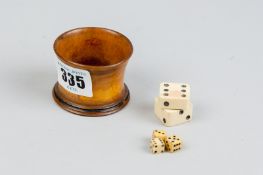 An olive wood dice cup with three dice and an ox bone screwable dice container