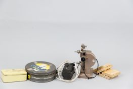 A Pathescope Ace projector with four 9.5mm films titled 'The Duet, Charlie Chaplin', 'Overcoat,