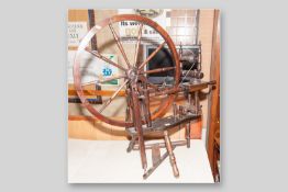 A 20th Century mixed wood treadle spinning wheel, 38 x 40 ins (96.5 x 101.5 cms)