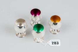 A set of four Gorham sterling silver pedestal goblet tots, three with coloured enamel interiors,