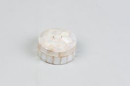 A circular mother of pearl patchbox