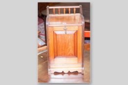 An Edwardian mahogany fall front coal box with spindle gallery back, 23.5 x 13.5 ins (59.5 x 34