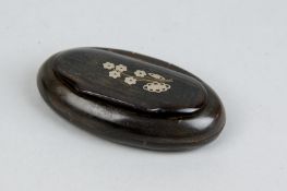 An oval 19th Century horn snuff box with floral silver inlay to the lid