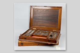 A mahogany cased set of optician's test lenses in lift-out tray and a similar type of oak box but
