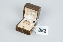 An eighteen carat gold three stone diamond dress ring having a centre diamond, visual estimate 1/3rd