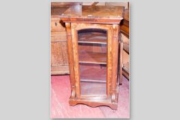 A Victorian walnut single glazed door music cabinet with box wood and ebony stringing, crossbanded