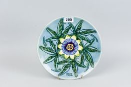 A Moorcroft pottery limited edition (97/500) 1992 year plate, decorated in the 'Passion Flower'