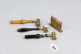 Two ebony handled brass shot measures and a wooden handled shot measure and a rack of seven de-