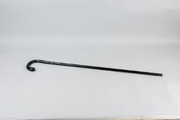 An Edwardian composition swordstick walking cane with hallmarked silver collar, with slight