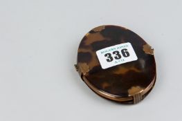 An oval tortoiseshell and metal mounted photo frame, stamped 'Fellows'