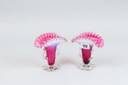 A pair of cranberry and milk glass vases, the clear glass feet with cut pontil, twin clear glass