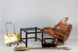 An early Victorian copper coal scuttle, an antique brass and iron trivet, a cast coffin shaped