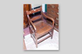 A 19th Century oak armchair with pegged joints on square supports, 33 x 21 ins (84 x 53.5 cms)