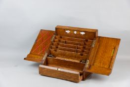 A well fitted golden oak stationery cabinet, twin opening doors and sliding bottom drawer, hinged
