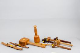 A selection of various wood and brass marking gauges, three wood shaves including an interesting