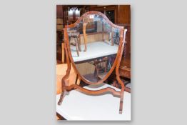 An Edwardian mahogany and boxwood line inlaid shield shaped toilet mirror with shaped stretcher