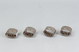 A set of four Continental Zilpla 90 oval napkin rings, each having raised rustic figures at work