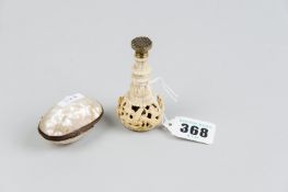 A mother of pearl small oval lidded shell case and an elaborately carved marine ivory seal