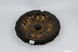 A black papier mache footed dish, shaped rim and gilt chinoisserie style decoration, 14 ins (35.5