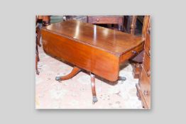 A Victorian mahogany twin flap Pembroke table on turned central column, splayed legs, brass hairy