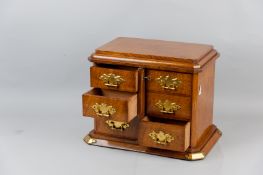 A Victorian oak Wellington type tabletop chest of drawers having a moulded top with chamfered