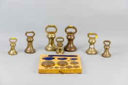 A boxed set of brass weights, 10 grms to 1 kg, in a painted wooden case along with a collection of