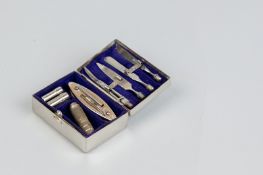 A gentleman's travelling miniature shaving and manicure box with mirrored lid in original