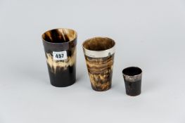 A horn and silver mounted beaker with glass bottom and two further horn and white metal mounted