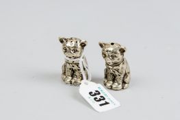 A pair of white metal seated cat salt and pepper condiments