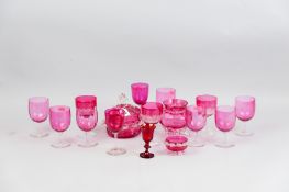 A group of cranberry glass to include twelve drinking glasses, a powder bowl and cover, a
