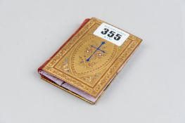 A yellow metal and enamel inlaid sewing case in the form of a New Testament