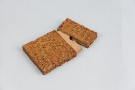 A heavily carved Oriental hardwood card case depicting numerous figures, temples and trees etc