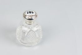 A glass dressing table scent bottle with hobnail cut panels and with hinged silver top, Birmingham