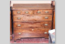 An antique oak chest of two over three drawers on bracket feet, replacement brass cup handles and