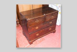 A Victorian two over two drawer chest with brass backplates and swing handles, standing on bracket