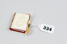 An Edwardian needle book with carved ivory cover