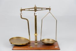 A 19th Century set of brass chemist's scales by R Tomlinson & Sons, Birmingham on a moulded edge