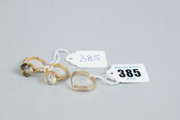 A nine carat gold tri-colour wishbone style dress ring, 2.2 grms and two yellow metal Middle Eastern