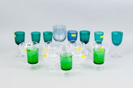 Six clear glass sundae dishes and eleven drinking glasses, various sizes and colours