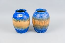 A good pair of Ruskin pottery vases of ovoid form with flared necks, mottled cobalt blue decorated