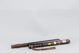 A Victorian decorated wooden truncheon marked 'Lambeth' along with a later plain example with
