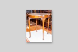 A circular burr walnut topped card table on Queen Anne supports, the top with brass clips and swivel