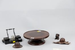 A Victorian mahogany 'Lazy Susan', 10.5 ins (26.5 cms) diameter, three carved wooden inkwell holders