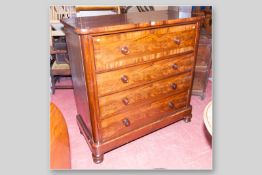 A Victorian mahogany chest of four drawers with turned wooden knobs, a top crossbanded deep drawer