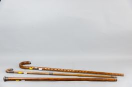Three various wooden walking canes, one with hallmarked silver top, one with hallmarked collar and
