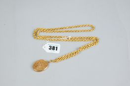 A nine carat gold muff chain, 32 ins (82 cms) long with a nine carat gold oval locket having a